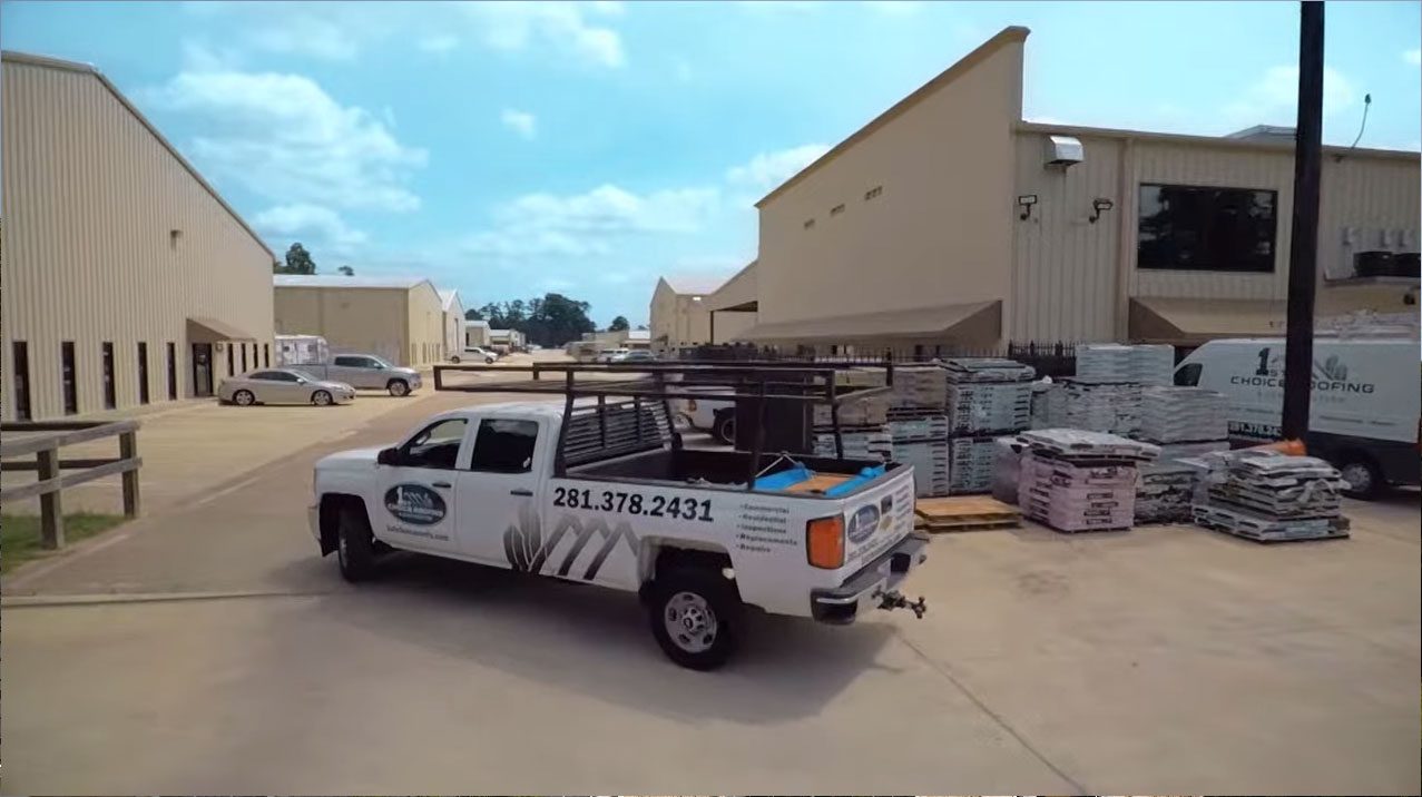 A white truck parked in front of a building.